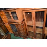 A pair of pine bedside chests; a reproduction media cabinet; a glazed door bookcase;
