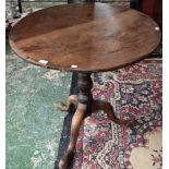 A George III mahogany tripod occasional table, near-circular tilting top, turned column,