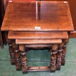 An oak nest of three tables, each with a rectangular top, turned supports,