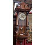 A mahogany Vienna wall clock, circular brass mounted cream enamel dial with bold Roman numerals,