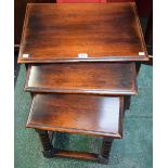 An oak nest of three tables, each with a moulded rectangular top, bobbin and ring turned supports,