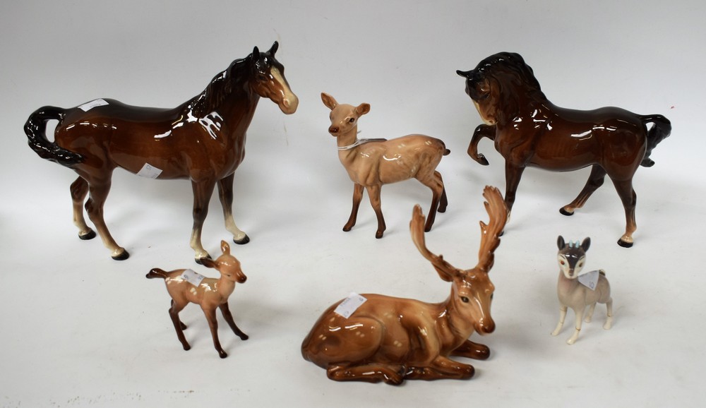 A Beswick study, of a chestnut mare, standing; another, stallion, hoof raised; a Beswick stag,