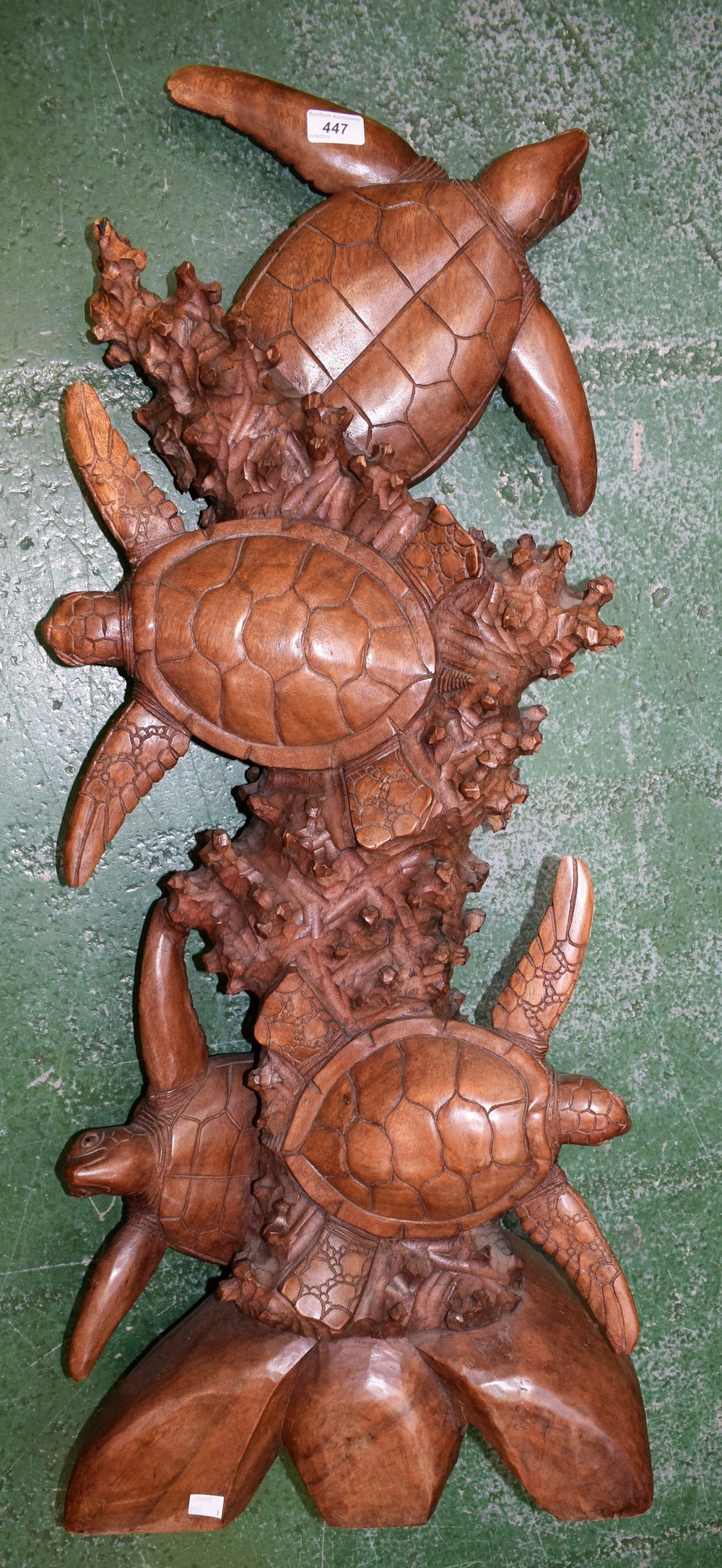 A floor standing hardwood carving, hawksbill turtles amongst coral,