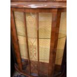 A 1920's single door bow front display cabinet, Art Nouveau central panel,
