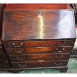 A George III mahogany bureau, fall front enclosing a small door,