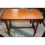 An Edwardian mahogany centre table, chamfered rectangular top, ring turned supports and stretcher,