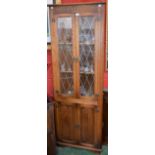 An Old Mill oak floor standing corner display cabinet; another,