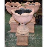 A painted reconstituted garden urn, moulded with stiff foliage,