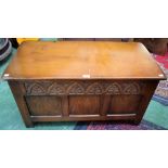 An oak blanket chest, hinged rectangular top above a three panel front, 91.