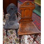A Victorian oak hall chair, domed cresting centred by a flowerhead,