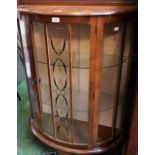 An early-mid 20th century bow front display cabinet