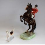 A Beswick huntsman astride rearing horse,