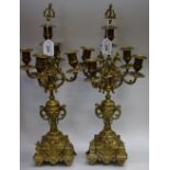 A pair of ornate brass five branch candlesticks (2)