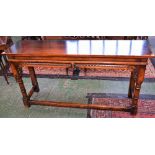 An oak console/side table, slightly oversailing rectangular top above a deep frieze,