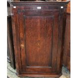 A George III oak wall hanging corner cupboard,