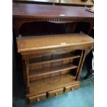 An oak console table, oversailing rectangular top above a conforming undertier, drawers to frieze,