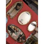 A gilt framed oval bevelled mirror;