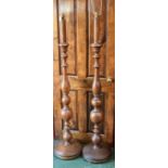 A pair of oak standard lamps, turned supports, circular bases,