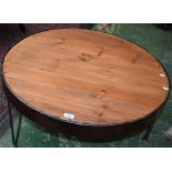 An industrial salvage style circular coffee table, cast metal frame, planked pine top,