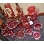 Cranberry Glass - a pair of single handled jugs,