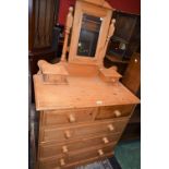 A pine dressing table, rectangular top above two short and three long drawers,