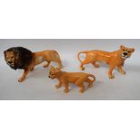 A Beswick model, of a lion, printed marks; two others, similar, lioness and cub,