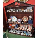 A George III mahogany open bookcase, broken arch pediment above an arrangement of shelves,