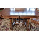 A 19th century mahogany dining table, rounded near-square top,