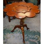 A Frederick Hintz inspired tea table, tilting top with circular reserves for tea wares,