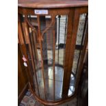 An early-mid 20th century walnut bow-front display cabinet, 118.