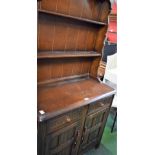 A Priory style Welsh type dresser, domed top above two plate racks,