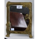 An Art Nouveau design brass rounded rectangular easel photograph frame,