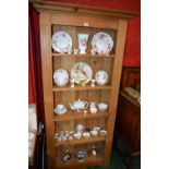 A pine open bookcase, outswept cornice above four shelves,