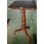 A George III style occasional table, rounded rectangular top, turned column, triform base,