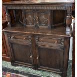 An oak court cupboard, rectangular top above a nulled frieze and a pair of small doors,