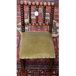 An Arts and Crafts oak child's chair, bobbin turned back and forelegs,