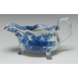 A Bow sauce boat, with three feet, painted in under glaze blue with foliage, 20cm wide, c.