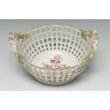 A Berlin two handled basket, painted with flowers, pierced sides, rustic handles, 17.