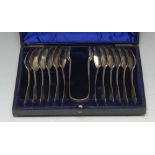 A set of twelve Victorian Provincial silver Fiddle pattern teaspoons and sugar bows,
