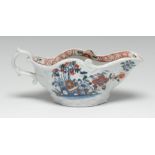 A Chaffers Liverpool rococo moulded sauce boat, decorated in underglaze blue,
