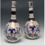 A pair late 19th Century Imari palette bottle vases and stoppers, in the manner of Derby,