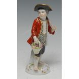 An early 20th century Meissen figure, of a gardener, he stands with hoe on his shoulders,