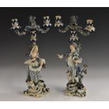 A pair of Meissen figural two branch two light candelabra, of a gallant and companion,