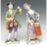 A pair of continental figures, of musicians, both in 18th century dress, she with drums,