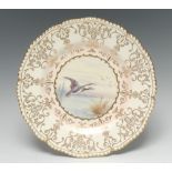 A Coalport circular plate, painted with a Brent Goose, with a gilt C scroll cartouche, 22cm diam,