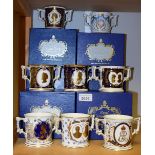 A collection of seven Royal Crown Derby royal commemorative two handled loving cups, boxed; another,