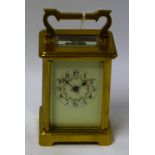 A lacquered brass carriage clock, five bevelled clear glass panels,