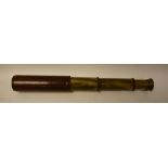 A brass three draw telescope, brown leather casing,