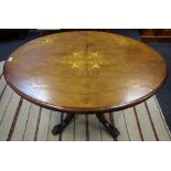 A Victorian mahogany loo table, oval top inlaid with urns and scrolls, five turned columns to base,