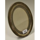 A large oval silver photograph frame, Birmingham 1920. 24cm x 18cm.